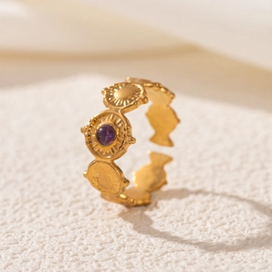 Close-up of 18K gold stainless steel open ring with purple stone and engraved texture