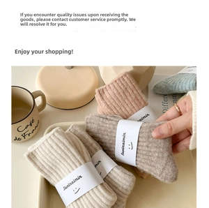 Detail of ribbed wool socks in earth tones with branded packaging and cozy props