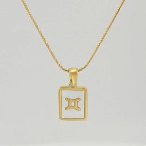 Detailed close-up of 18K gold stainless steel Gemini pendant necklace with white shell inlay