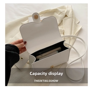 Internal view of a white leather crossbody bag showing space for smartphone and essentials