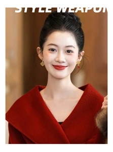 Detail of elegant hollow flower drop earrings with red beads on female model