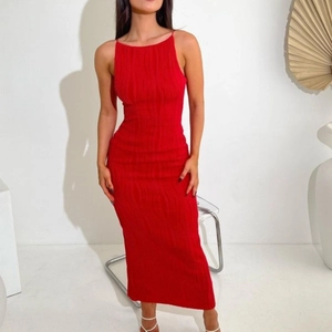 Detail of red slim fit maxi dress featuring textured vertical pleats and thin straps