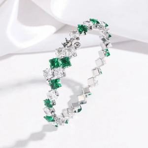 Detail showing square green and white zircon crystals on a silver stainless steel bangle