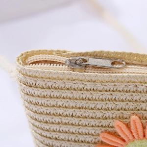 Detail of children straw bag with zipper closure and sunflower embroidery accent