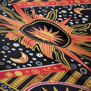 Close-up of bohemian sun and moon tapestry fabric showing detailed weaving texture