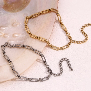 Detailed macro view of 14K gold plated paperclip chain anklet with round bead connector