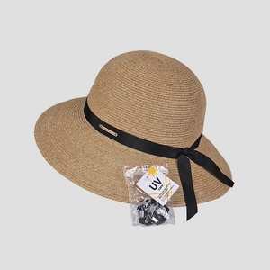 Detail of UV-protective straw hat texture with black ribbon and windproof cord