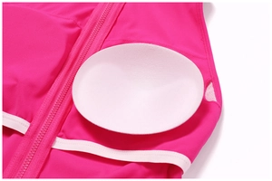 Close-up of rose red yoga bodysuit featuring a zipper and removable white chest pads