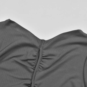 Detail of V-neck ruching and charcoal grey ribbed knit texture on long sleeve top
