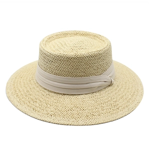 Elegant beige straw boater hat with wide ribbon for sun protection and summer beach outings