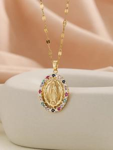 Detailed macro view of Virgin Mary gold pendant with multi-colored cubic zirconia stones