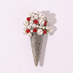 Detail of ice cream brooch with white faux pearls and red rhinestones on silver cone
