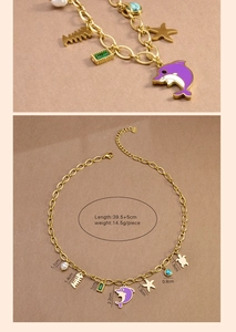Detailed view of ocean theme gold chain necklace with dolphin charms and pearls