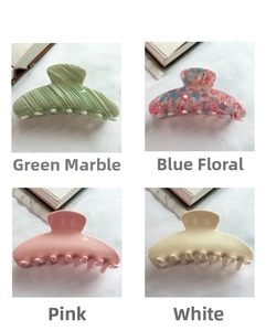 Collage of four large acetate hair claws in green, floral blue, pink, and white colors