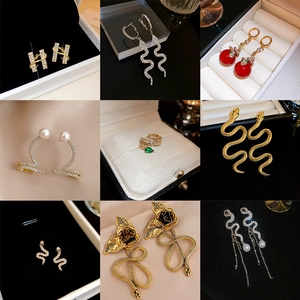 Collection of vintage gold and silver snake earrings with crystals and pearls
