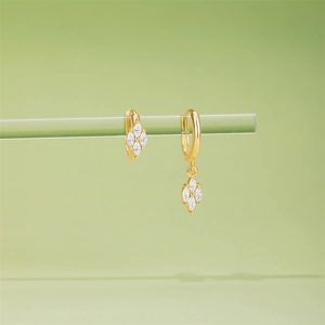 Macro detail of gold marquise petal hoop earrings with sparkling cubic zirconia