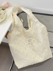 White jacquard floral lace tote bag with shoulder strap and woven logo patch