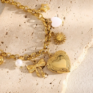 18K gold plated stainless steel heart and butterfly charm bracelet on beige stone
