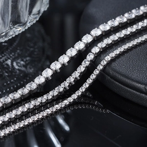 Macro shot of three sizes of s925 silver tennis bracelets with white zircon on black leather
