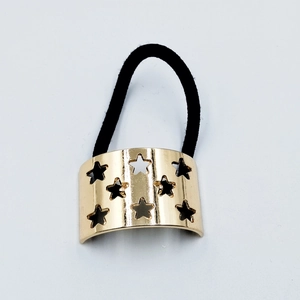 Detail of black elastic hair tie with golden alloy star cutout metal ornament