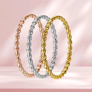 Detailed close-up of three twisted rope rings in rose gold, silver, and gold finish