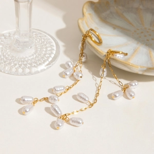 Elegant gold titanium steel long tassel earrings with irregular white pearls for women