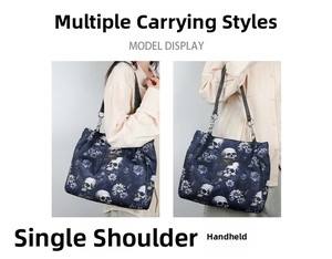 Detail of dark blue tote bag with white skull floral print and metal chain strap