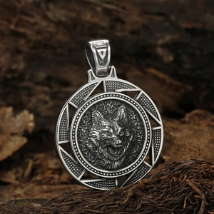Vintage stainless steel viking wolf head pendant necklace on a rustic wood background