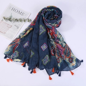 Close-up detail of dark blue cotton linen scarf with geometric patterns and fringe edges