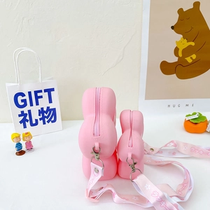 Detail of pink silicone camellia crossbody bags in two sizes with lucky flower straps