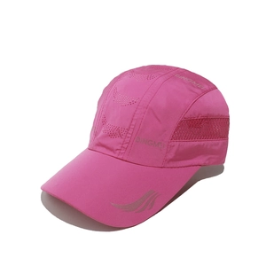 Detailed view of pink breathable baseball cap with laser-cut holes and side brand logo