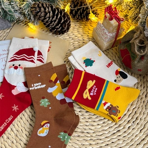 Detailed knit patterns of Christmas cotton socks featuring Santa and festive pine cone decor