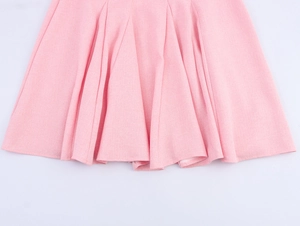 Detailed macro view of pink pleated hem showing high-quality woven fabric texture
