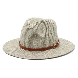 Summer Panama straw hat with brown leather band and gold buckle on white background