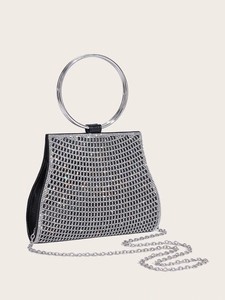 Detail of elegant black evening clutch bag with sparkling rhinestones and round silver handle