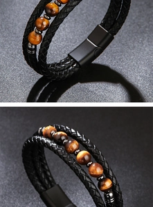 Detail of multi-layer black braided leather bracelet with tiger eye beads and magnetic clasp