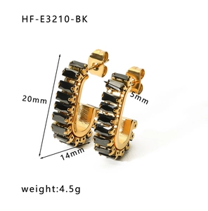 Detail view of gold stainless steel C-hoop earrings with black square zirconia stones