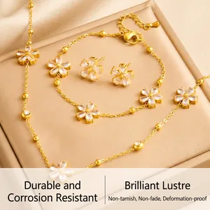 Detailed macro of gold flower jewelry set featuring clear crystal stones and bead chain