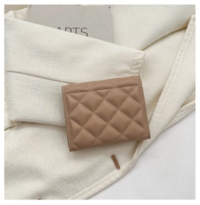 Close-up of khaki quilted leather square wallet on an aesthetic cream background