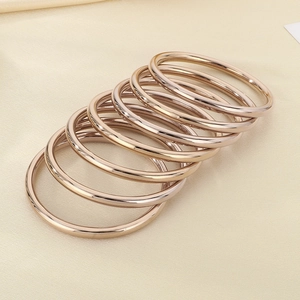 Detail view of 7-piece 18k gold plated stainless steel stacked bangles set