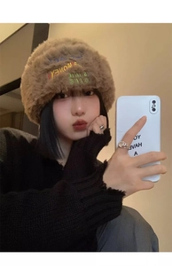 Detailed close-up of dark brown fuzzy knit beanie with colorful MONEY SIMPLE LIFE embroidery