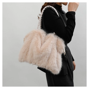 Detail showing the fluffy pink plush texture and white braided rope handle on the tote bag