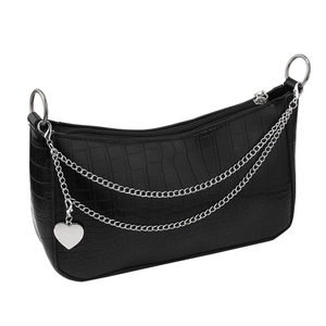 Detail of black crocodile texture faux leather bag with silver chain and heart charm