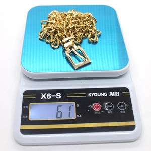 Close-up of hip-hop style gold metal chain belt weighing 61g on a scale