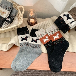 Detail of wool blend socks with cute puppy motif and ethnic geometric patterns