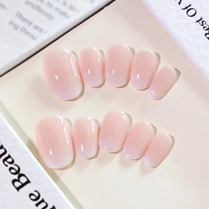 Pink and white gradient French press-on nails with a glossy short oval design