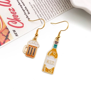 Asymmetric acrylic beer bottle and mug earrings on magazine background for Oktoberfest
