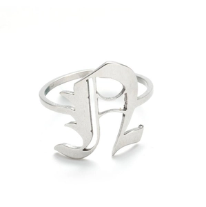 Macro detail of silver gothic letter R ring with a polished vintage streetwear finish