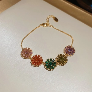 Detail of 18k gold plated bracelet with five colorful zircon flower charms and lobster clasp