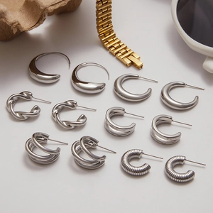 Assorted silver stainless steel earrings in geometric designs on a clean white background